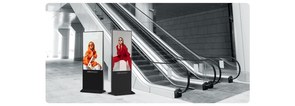 Wall-mounted digital signage menu boards above a café counter